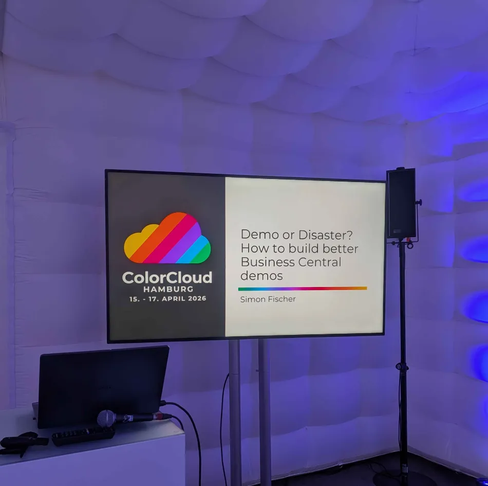 Photo of the empty session room with the title slide on a monitor